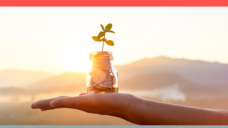 Person's hand holding up jar containing their pension money and plant sapling, symbolizing the switch to a net zero pension